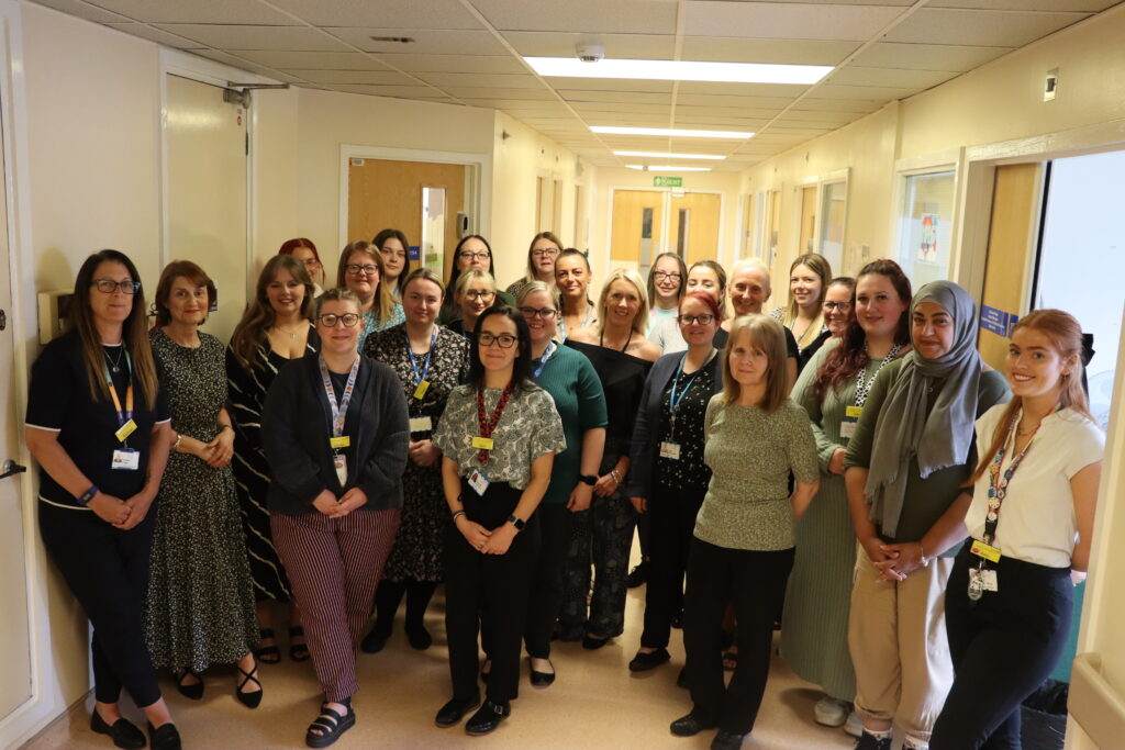 Support team standing in a corridor in Hartlepool.