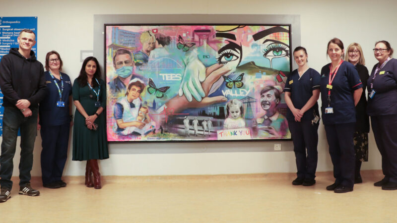 Artist Lucas Roy with his painting and respiratory staff.