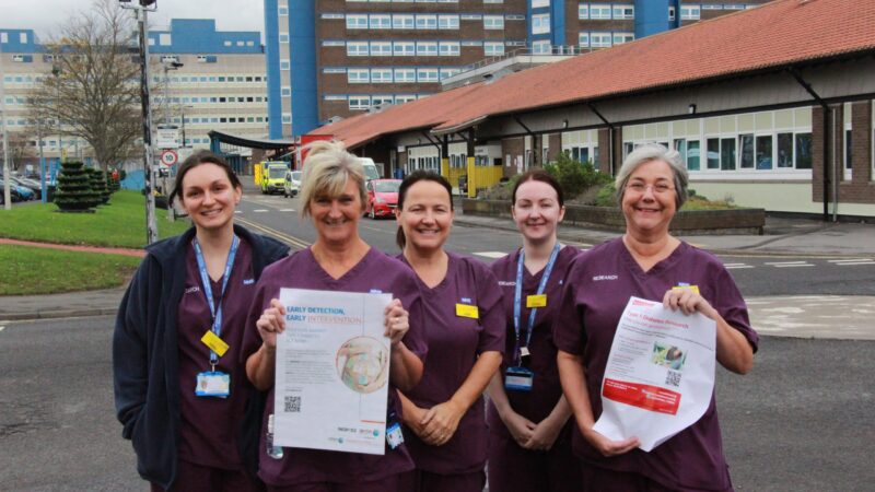 Members of the research team outside North Tees Hospital. Two of them hold posters for the diabetes studies.