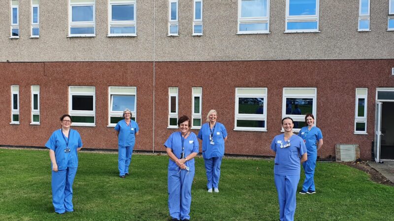 Staff who ran the vaccine trial. They stand outside the University Hospital of Hartlepool.